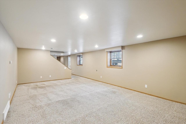 basement with recessed lighting, baseboards, and carpet flooring