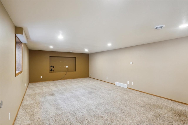 finished below grade area featuring recessed lighting, visible vents, and carpet floors