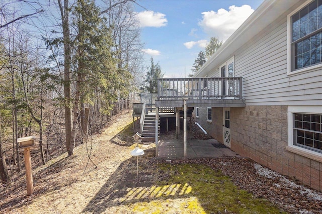 view of yard featuring a patio area, stairway, and a deck