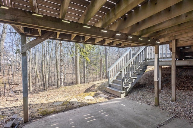 view of patio / terrace featuring stairway and a view of trees