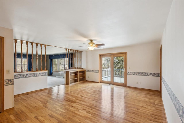 unfurnished living room with wood finished floors, a healthy amount of sunlight, and ceiling fan