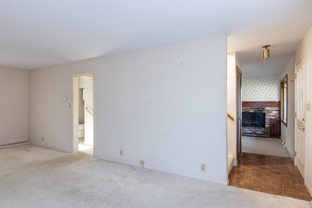 carpeted spare room featuring baseboards