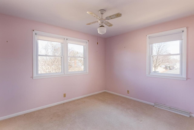 empty room with light carpet, visible vents, baseboards, and ceiling fan