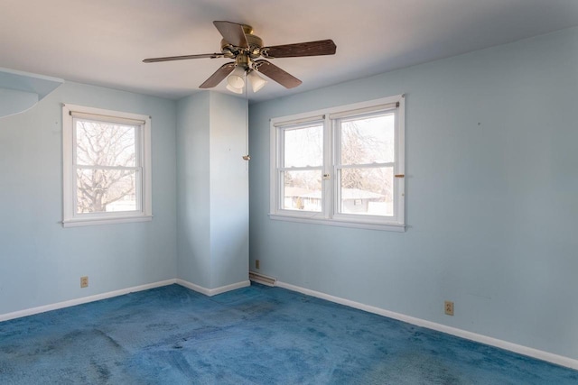 empty room featuring baseboards, carpet, and a ceiling fan