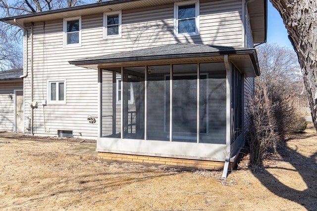 back of property with a sunroom