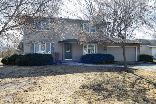 traditional home featuring an attached garage and concrete driveway