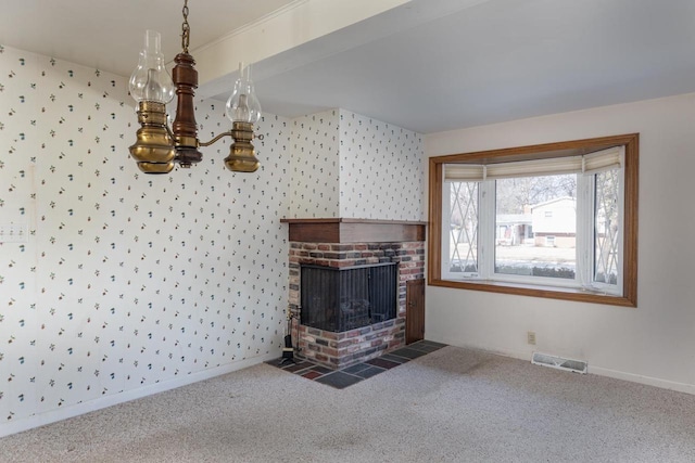 unfurnished living room featuring wallpapered walls, carpet flooring, baseboards, and visible vents