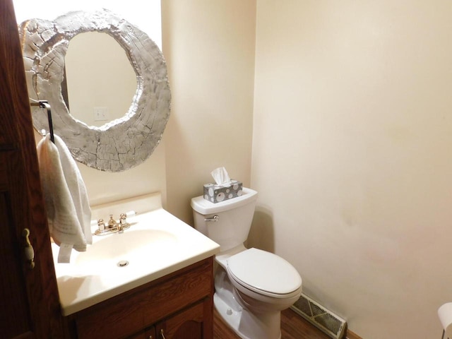 bathroom with visible vents, toilet, and vanity