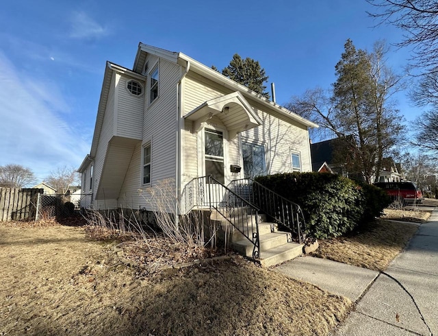 view of side of home featuring fence