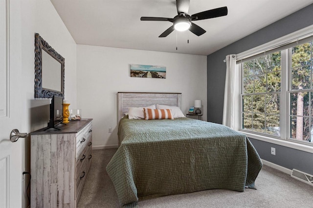 carpeted bedroom featuring visible vents, ceiling fan, and baseboards