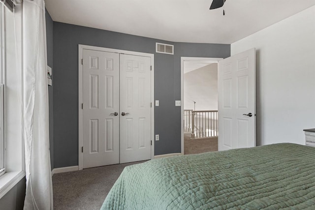 bedroom with carpet, baseboards, visible vents, ceiling fan, and a closet