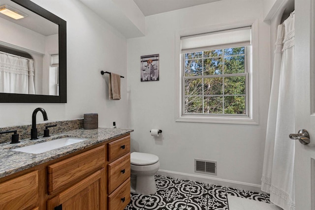 full bath with tile patterned floors, toilet, visible vents, and a wealth of natural light