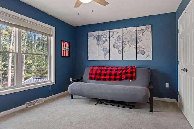 sitting room featuring visible vents, baseboards, carpet, and ceiling fan