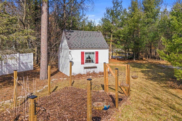 view of outbuilding with an outdoor structure and fence