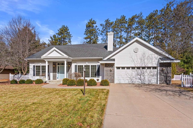 view of front of house with a front lawn, driveway, fence, an attached garage, and a chimney