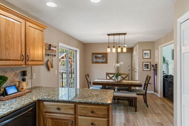 kitchen featuring dishwasher, light wood-type flooring, decorative backsplash, a peninsula, and brown cabinetry