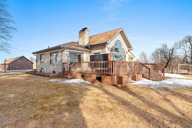 rear view of house featuring a deck and a chimney