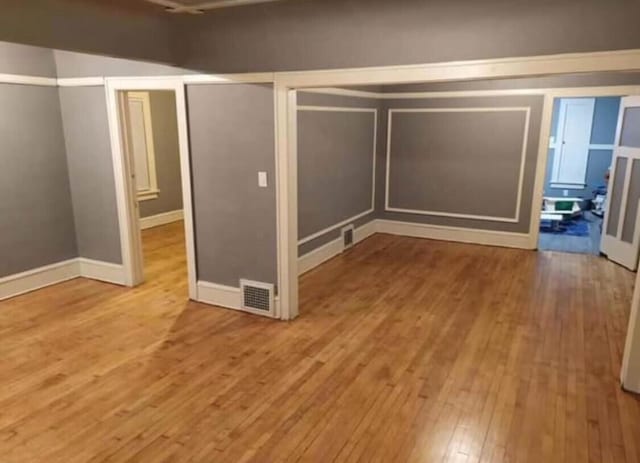 unfurnished bedroom featuring visible vents and wood-type flooring