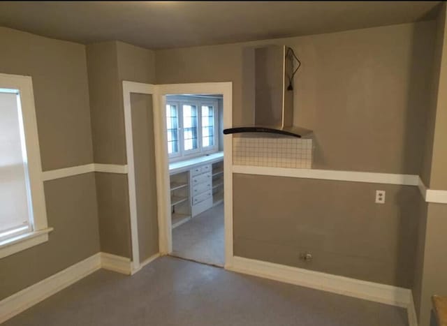 carpeted spare room with baseboards