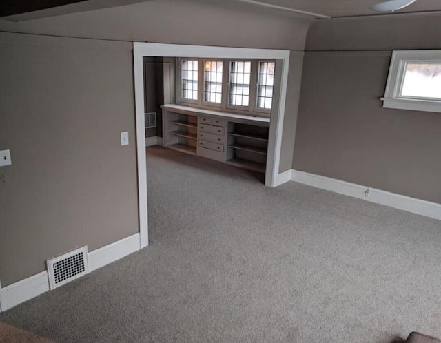 interior space featuring visible vents, baseboards, and carpet floors