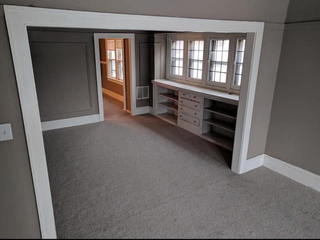 unfurnished bedroom with visible vents, baseboards, and carpet