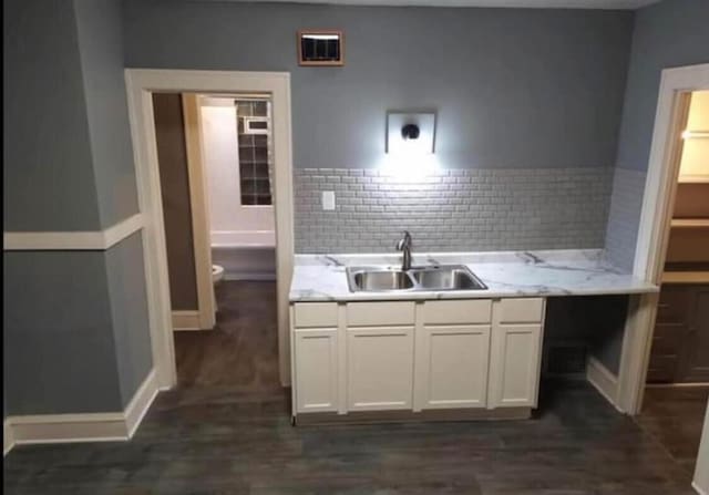 kitchen featuring a sink, visible vents, white cabinets, and light countertops