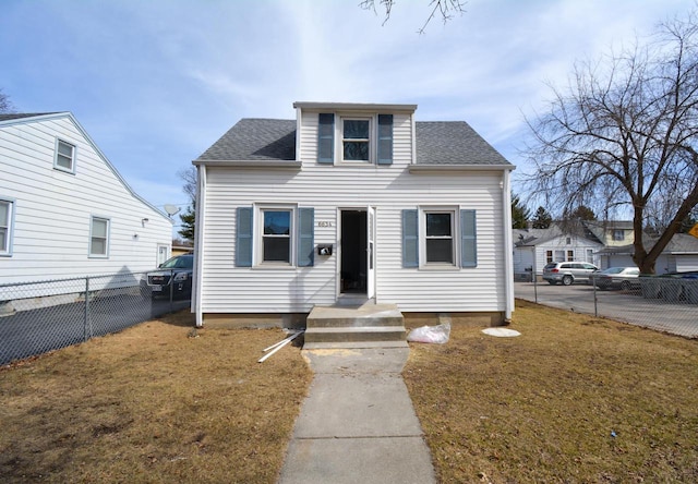 bungalow featuring roof with shingles, a front yard, and fence