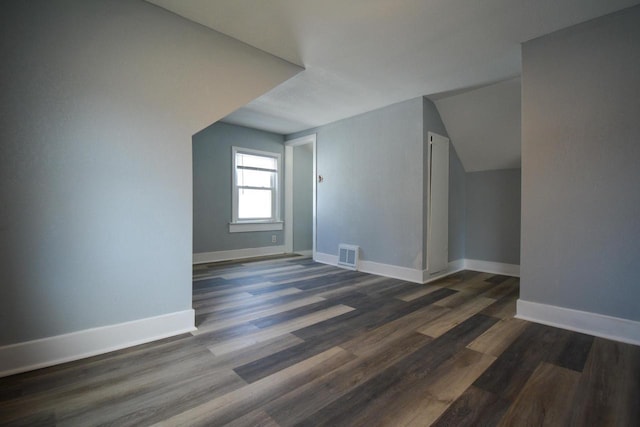 bonus room featuring visible vents, baseboards, and dark wood-type flooring