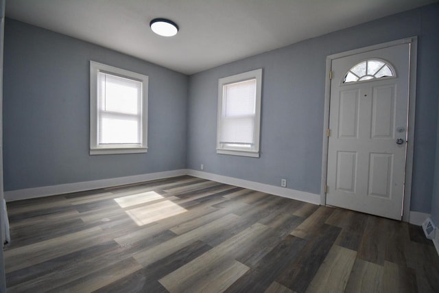 entryway featuring baseboards and dark wood-style flooring