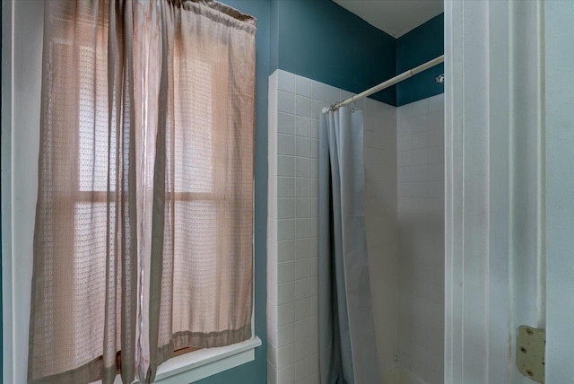 full bath featuring tiled shower