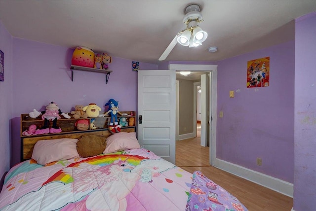 bedroom with ceiling fan, light wood-type flooring, and baseboards