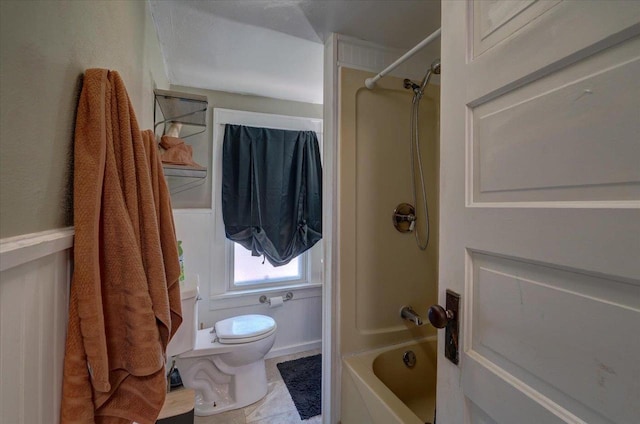 bathroom with toilet,  shower combination, and tile patterned flooring