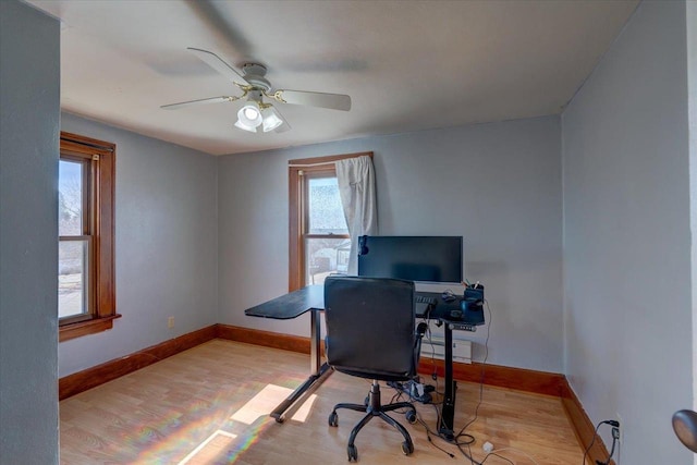 office featuring wood finished floors, baseboards, and ceiling fan