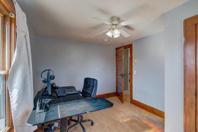 office with light wood-style floors, baseboards, and ceiling fan