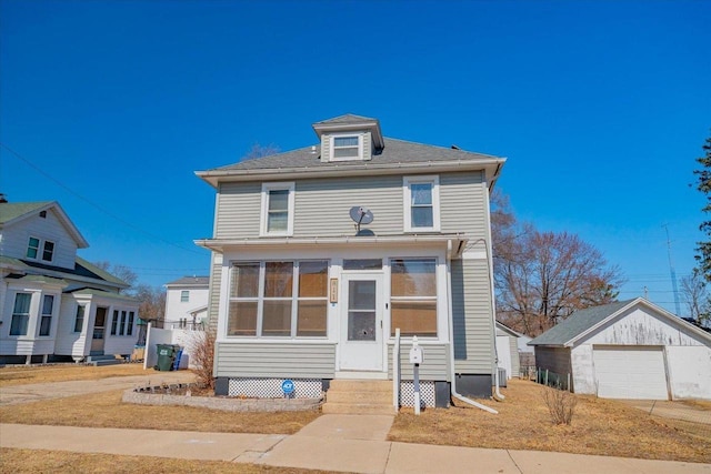 american foursquare style home featuring entry steps, an outdoor structure, a garage, and a sunroom