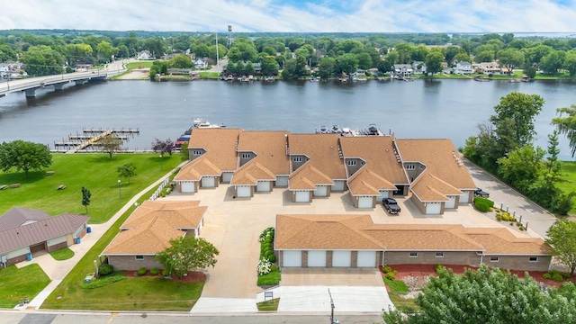 drone / aerial view with a residential view and a water view