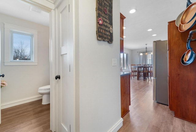 corridor with recessed lighting, light wood-style flooring, and baseboards