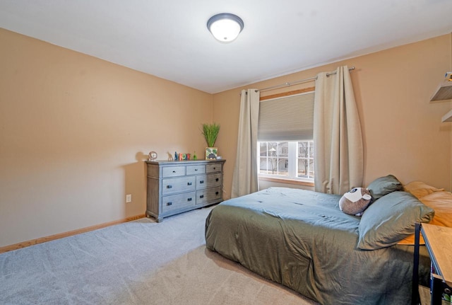 carpeted bedroom featuring baseboards