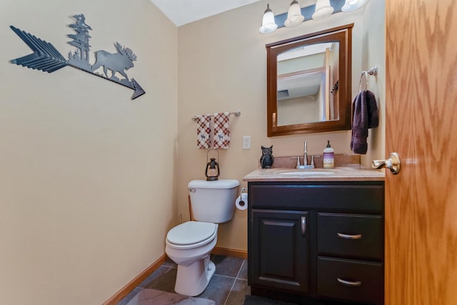 half bathroom with tile patterned flooring, toilet, vanity, and baseboards