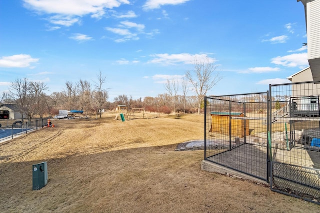 view of yard with a playground and fence