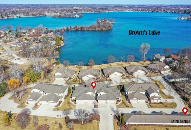 drone / aerial view featuring a residential view and a water view