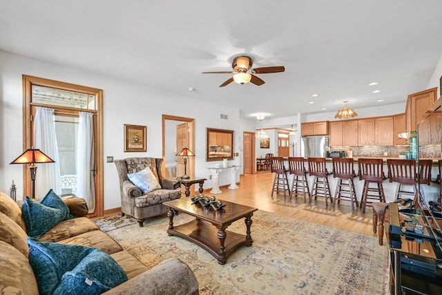 living room featuring visible vents, recessed lighting, a ceiling fan, and light wood-style floors