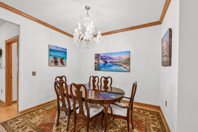 dining space featuring baseboards, a notable chandelier, and ornamental molding