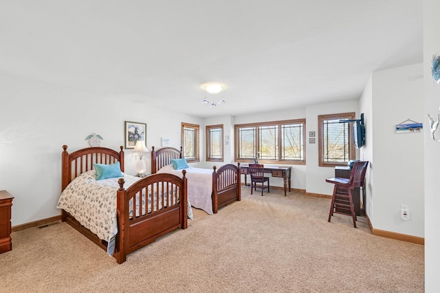 carpeted bedroom featuring baseboards