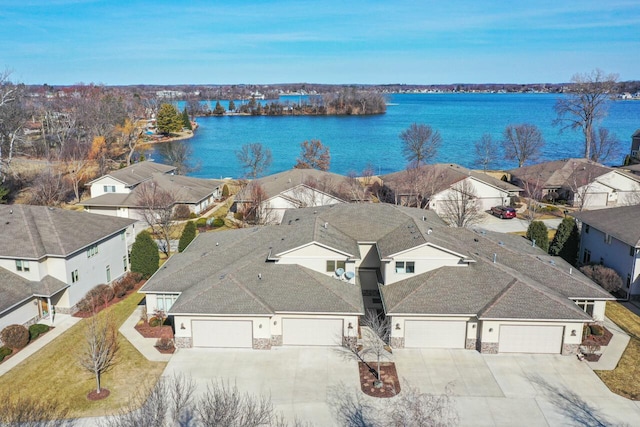 drone / aerial view with a residential view and a water view