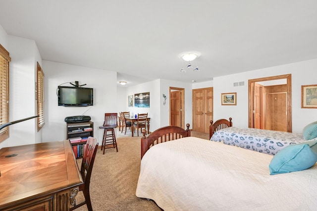 bedroom with visible vents and carpet floors