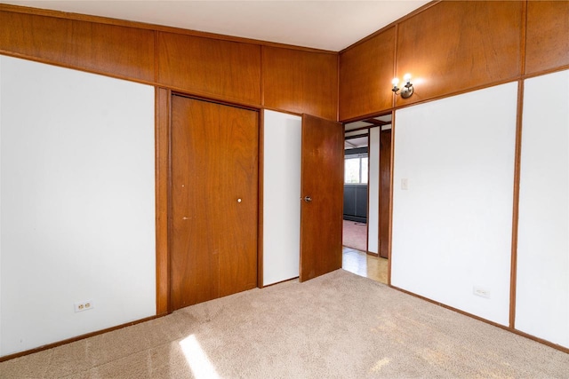 unfurnished bedroom with a closet and carpet flooring