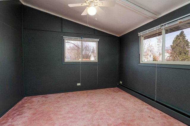 empty room with a baseboard heating unit, vaulted ceiling, ceiling fan, and light carpet