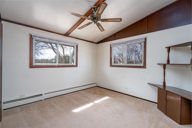 unfurnished room featuring a wealth of natural light, light carpet, baseboard heating, and vaulted ceiling