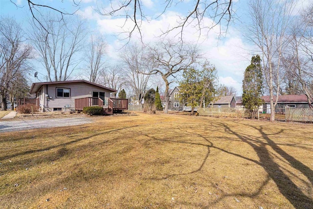 view of yard featuring a deck and fence